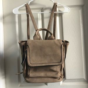 Nude colored suede backpack with gold and black zipper detail